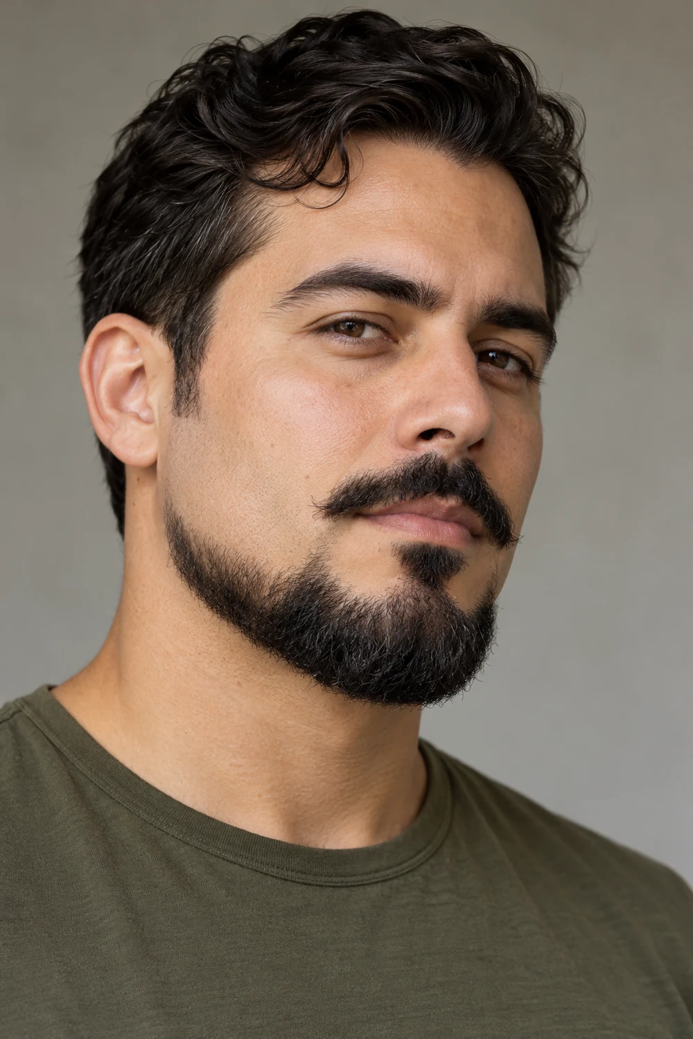 Adult man with a broad Balbo beard, clean upper cheeks, visible sideburn gaps, and a detached mustache.