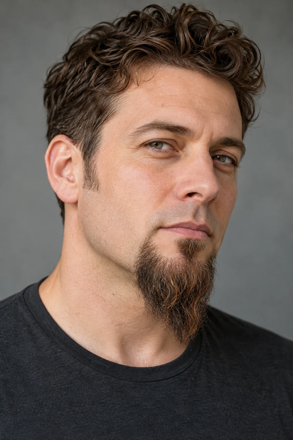Three-quarter portrait showing a long tapered goatee with a distinct soul patch and clean upper lip.