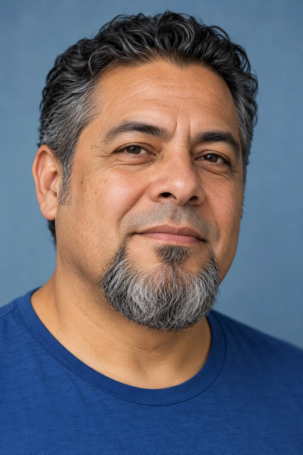 Fictional adult man with a broad, rounded salt-and-pepper goatee, separate subtle soul patch, clean-shaven cheeks, and bare upper lip.
