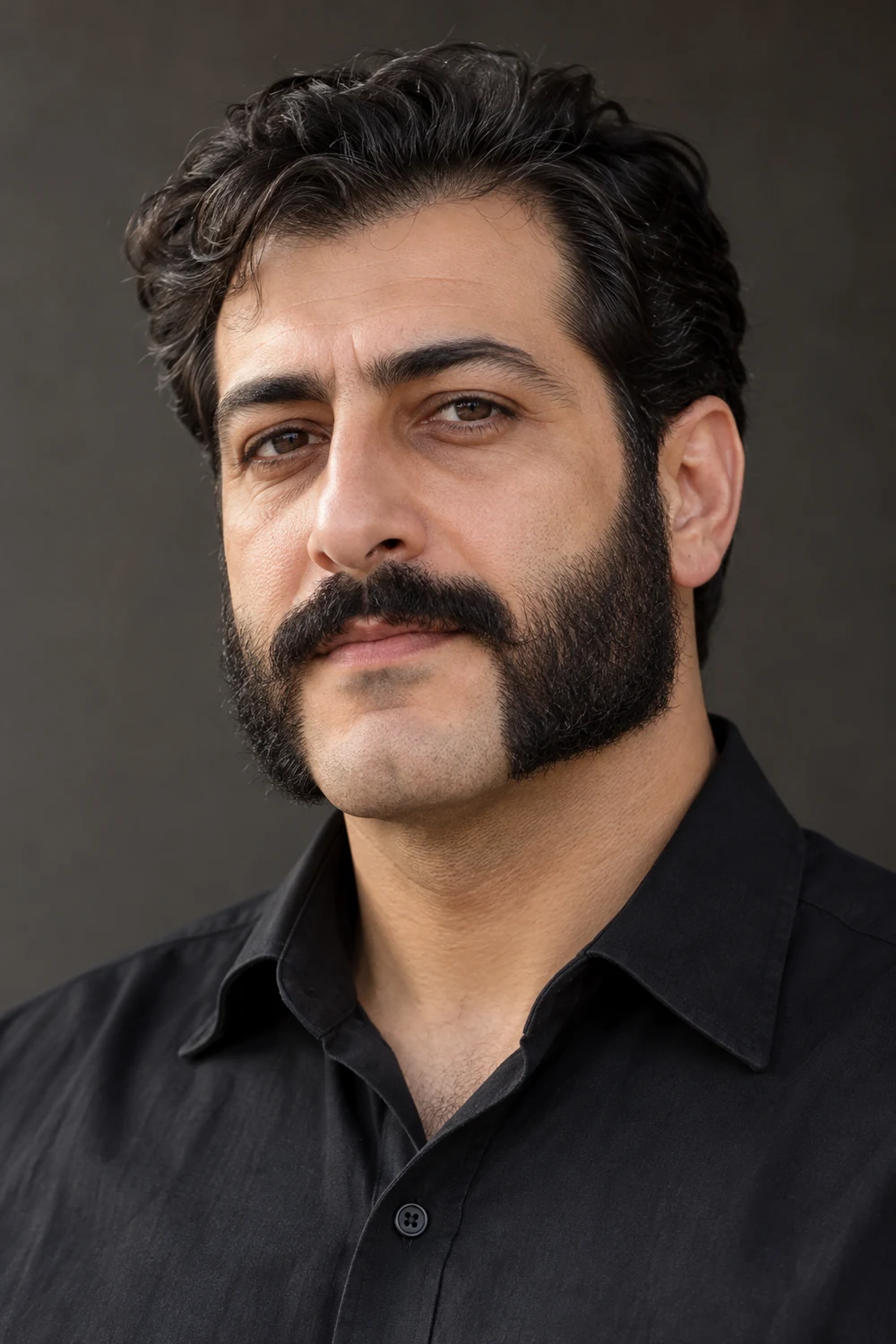 A fictional adult man with dark squared mutton chops joined to a mustache, framing a clean-shaven chin.