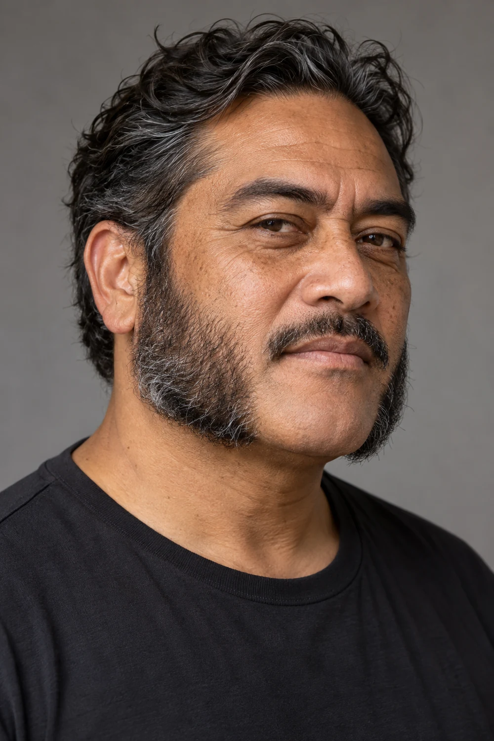A fictional middle-aged Māori man in a three-quarter portrait with wavy salt-and-pepper mutton chops, a shaped mustache, and a clean chin.