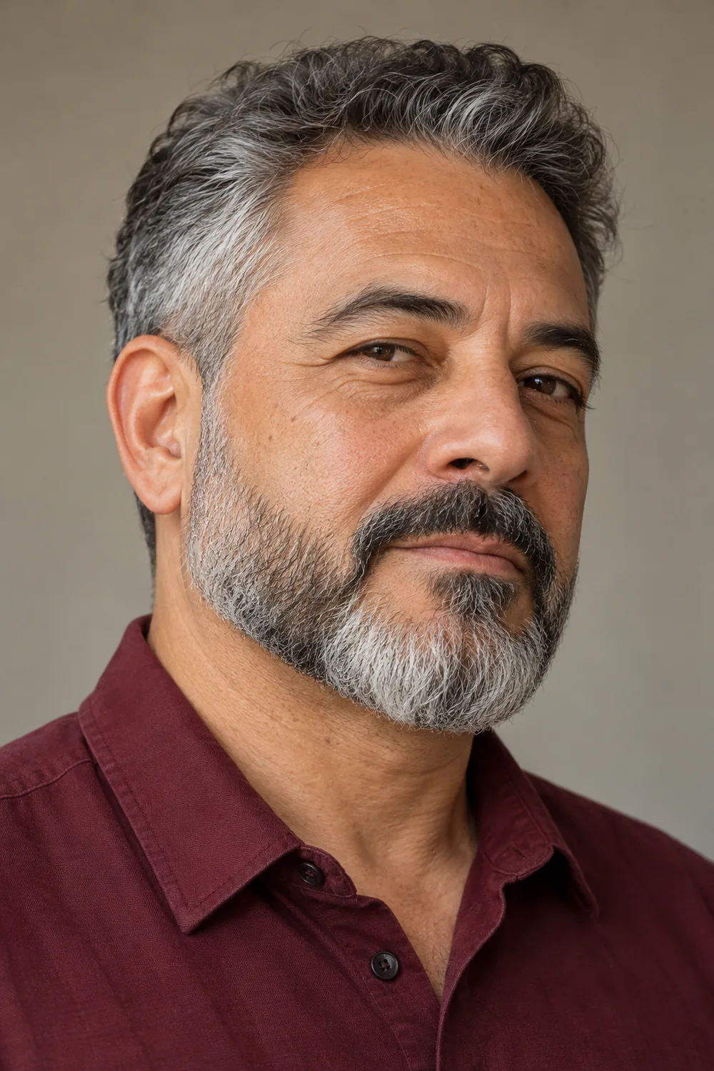Adult man with short tapered cheeks, fuller chin, softly defined cheek line and connected mustache.