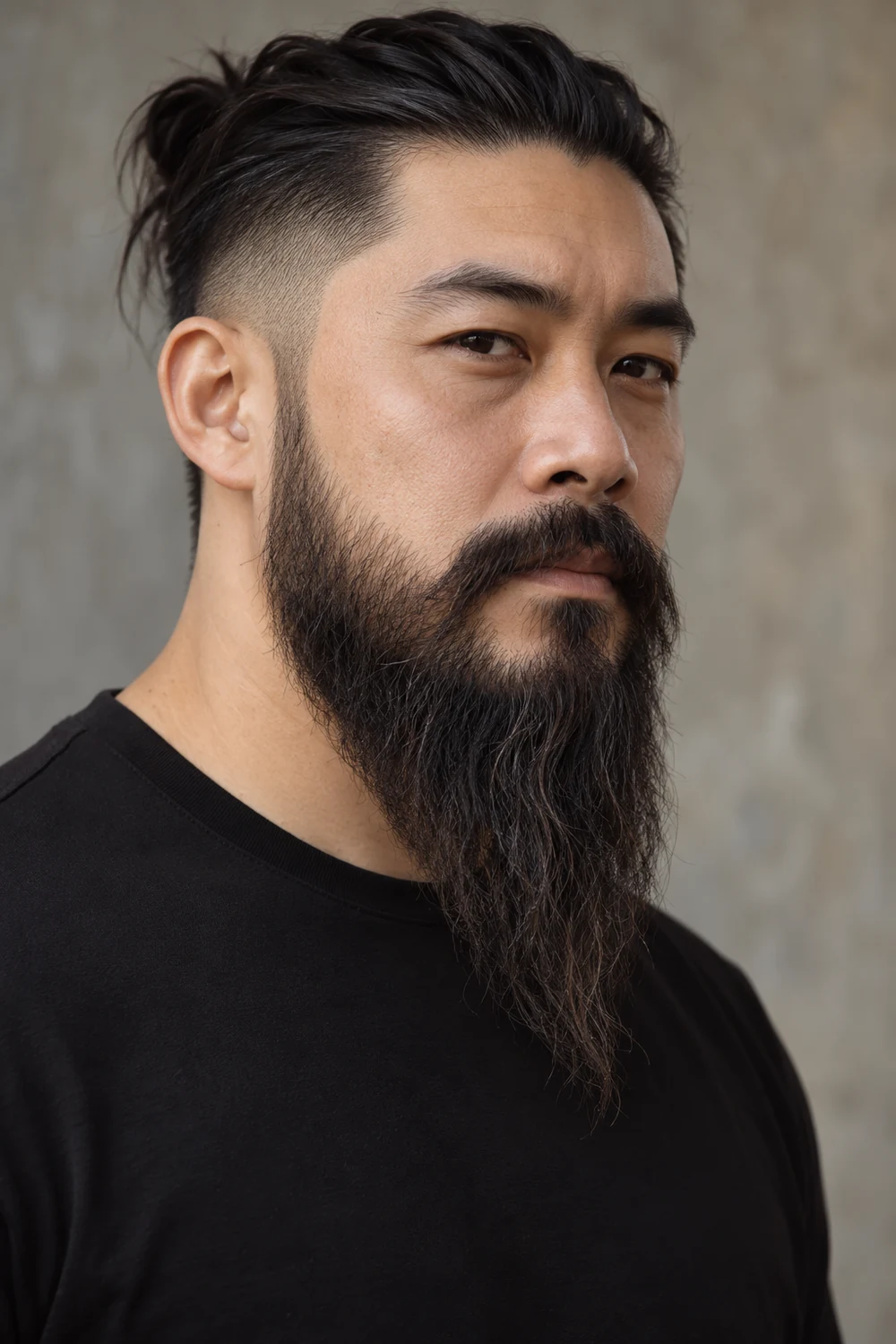 Three-quarter portrait of an adult East Asian man with a long, dark full beard, high clean cheek line, connected mustache, and softly pointed tapered tip.